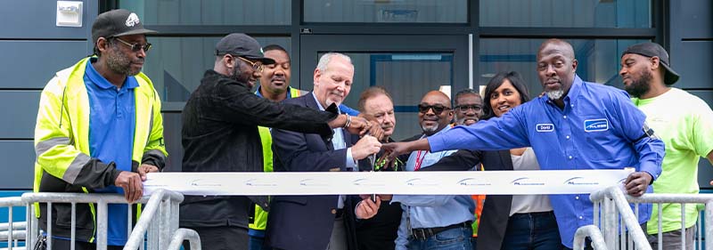 group of people at the P&G facility cutting a ribbon